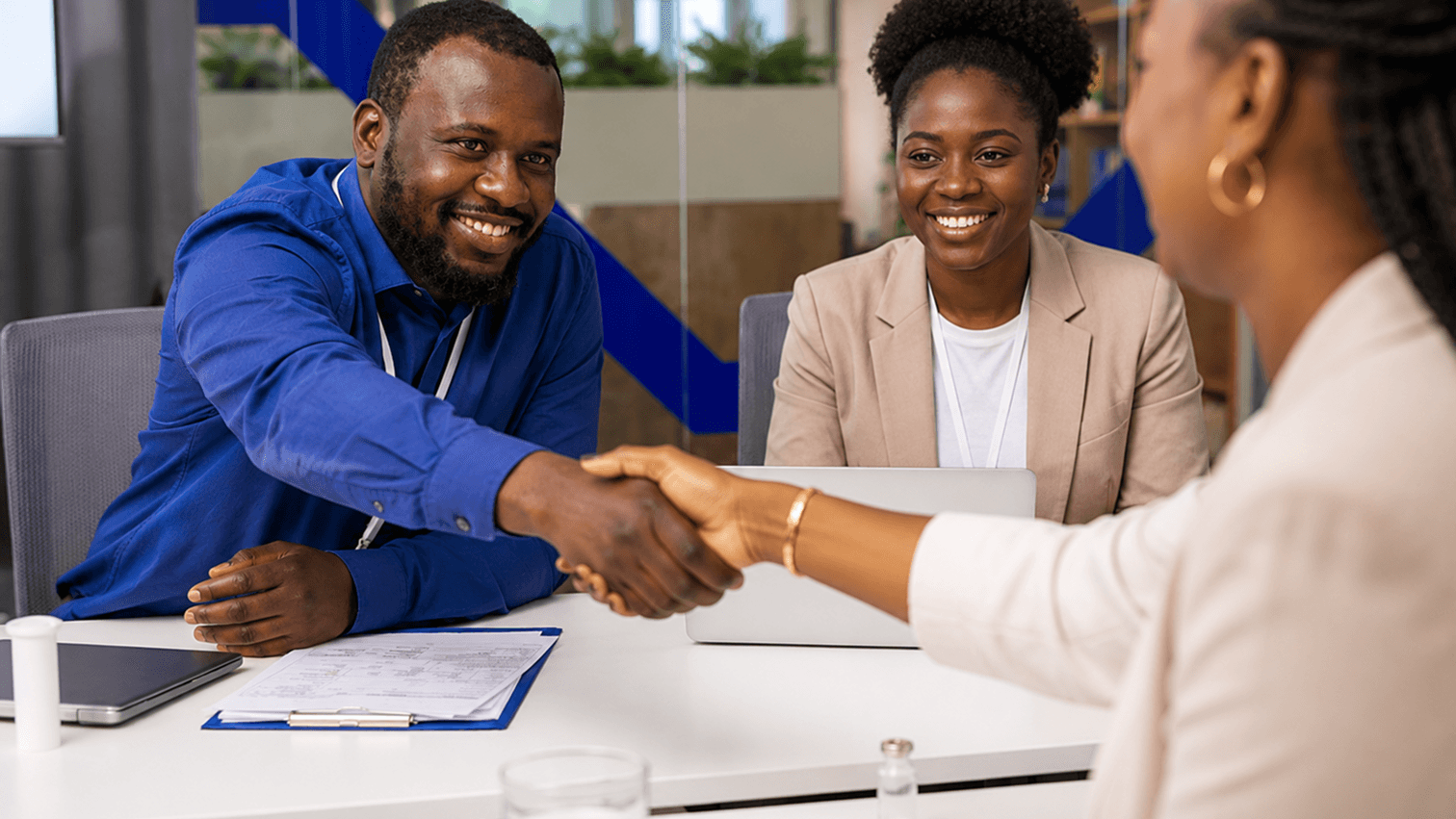Two partnership teams shaking hands after a meeting