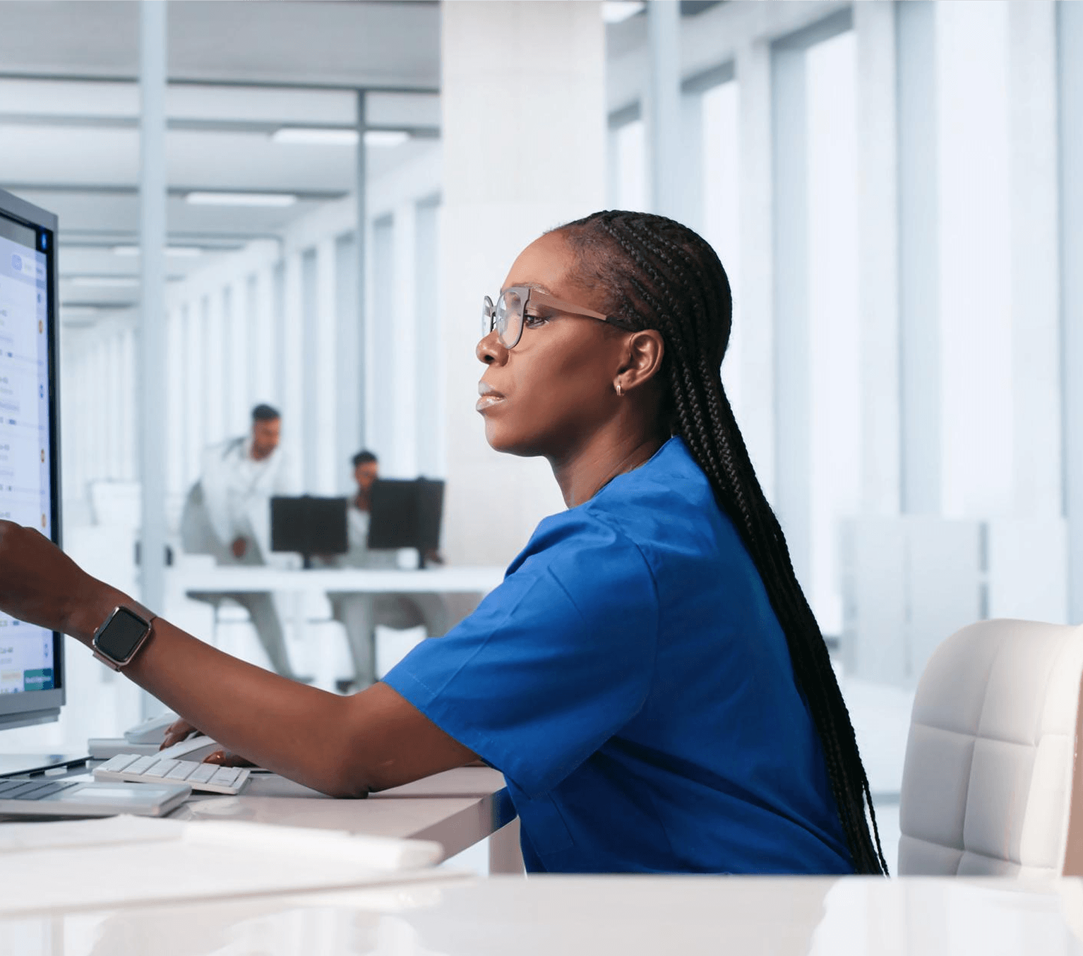 A provider reviewing patient records on her clinical dashboard